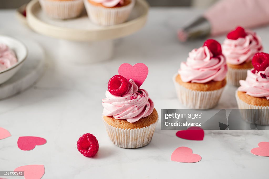 Freshly made raspberry cupcakes on kitchen counter