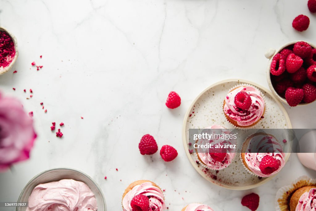 Freshly prepared raspberry cupcakes on kitchen counter