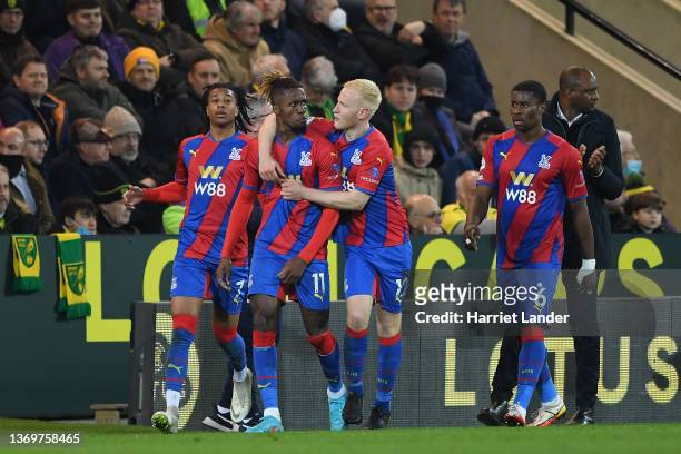 Wilfried Zaha of Crystal Palace celebrates with teammates Michael Olise and Will Hughes after scoring his team's first goal during the Premier League...