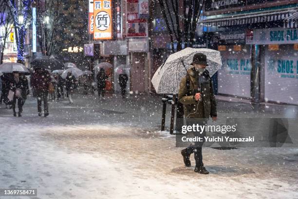 Man walks through Shinjuku area during heavy snow on February 10, 2022 in Tokyo, Japan. Due to the expected heavy snowfall at leasts four highway...