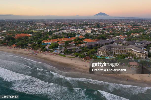 sunset over the famous seminyak beach in bali, indonesia - agung volcano in indonesia stock pictures, royalty-free photos & images