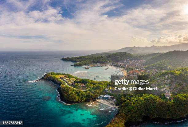 dramatic aerial view of the padang bai village and coastline in bali, indonesia - bali luxury stock pictures, royalty-free photos & images