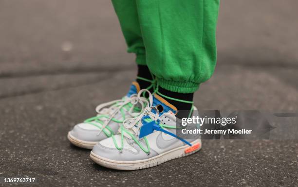Sonia Lyson is wearing Nike x Off White beige sneaker, Zara green joggingpants, H&M teddy jacket and Bottega Veneta beige pouch on February 09, 2022...