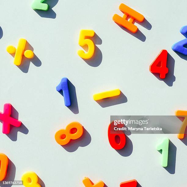 numbers and mathematical signs on a light blue background. - magnet stock-fotos und bilder