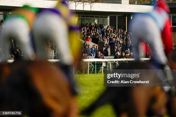 Racegoers look on as runners pass the grandstands during The M1 Agency Handicap Chase at Huntingdon Racecourse on February 10, 2022 in Huntingdon,...