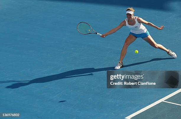 Mona Barthel of Germany returns a shot to Yanina Wickmayer of Belgium during the singles final match during day seven of the 2012 Hobart...