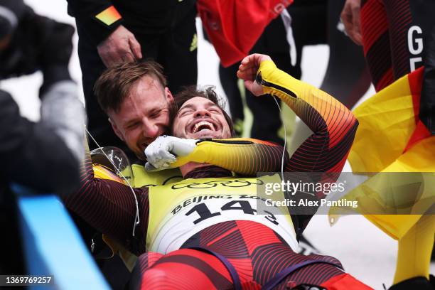 Tobias Wendl and Tobias Arlt of Team Germany react after winning gold during the Luge Team Relay on day six of the Beijing 2022 Winter Olympics at...