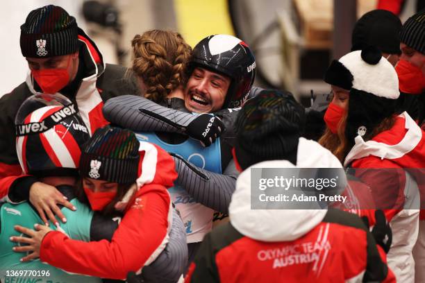 Madeleine Egle and Lorenz Koller of Team Austria react after sliding during the Luge Team Relay on day six of the Beijing 2022 Winter Olympics at...