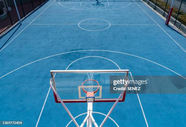 drone point view of empty basketball court - streetball stock-fotos und bilder