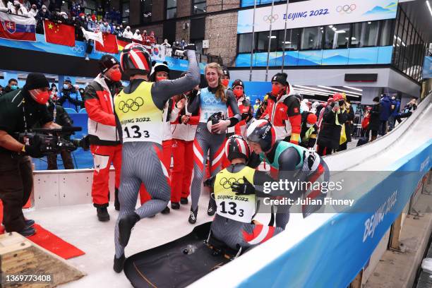 Lorenz Koller , Madeleine Egle , Thomas Steu and Wolfgang Kindl of Team Austria react after sliding during the Luge Team Relay on day six of the...