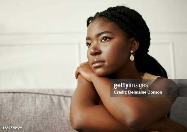 shot of a young woman looking depressed at home - depression sadness stock pictures, royalty-free photos & images