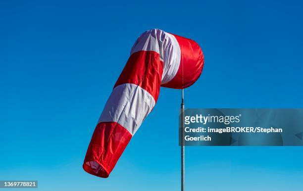 a windsock hangs on a mast at munich airport, bavaria, germany - munich airport stock pictures, royalty-free photos & images