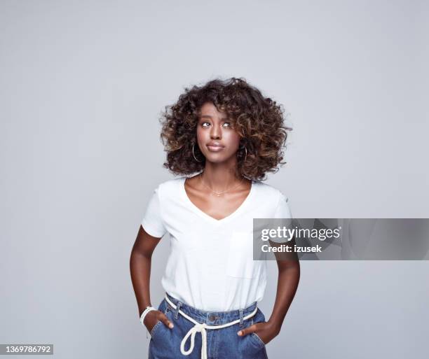 thoughtful young woman in white t-shirt - black t shirt stock pictures, royalty-free photos & images