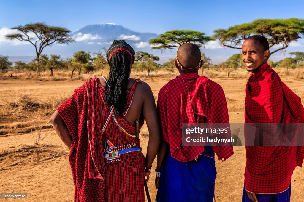 Warriors from Maasai tribe looking at Mount Kilimanjaro, Kenya, Africa