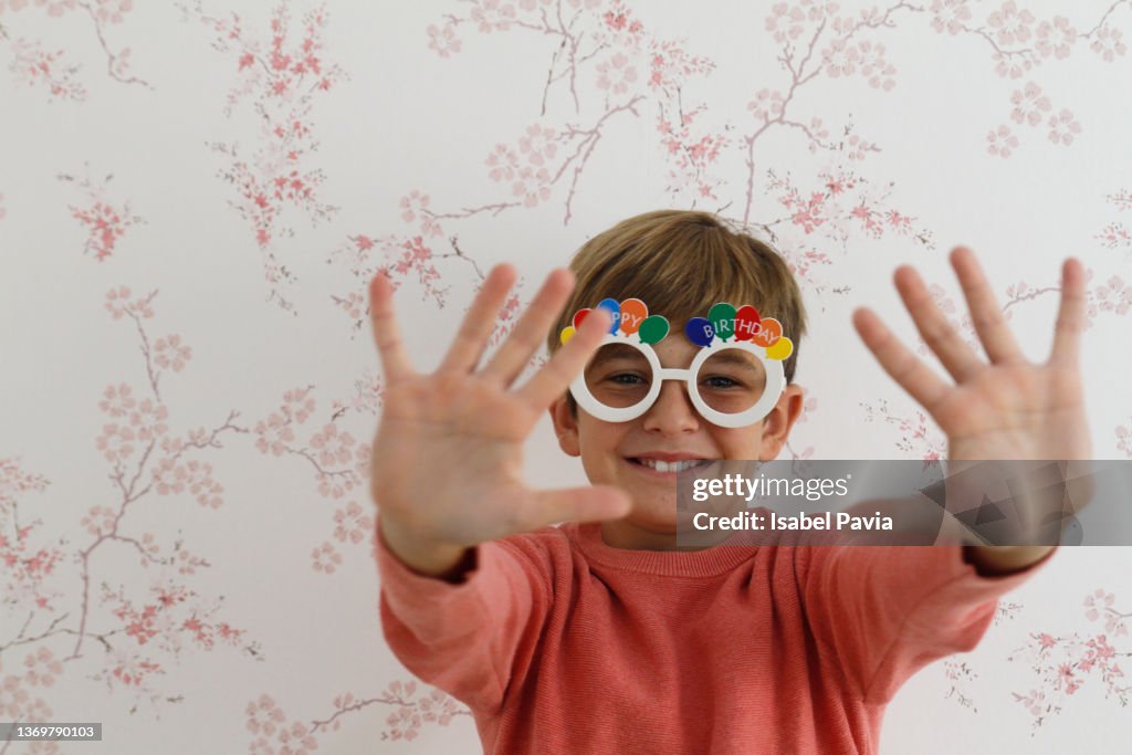 Boy holding out hands with ten fingers