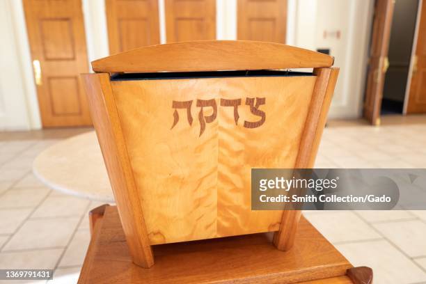 Tzedakah box with Hebrew letters reading Tzedakah, used for charitable giving, in the foyer of a synagogue in Lafayette, California, January 20, 2022.