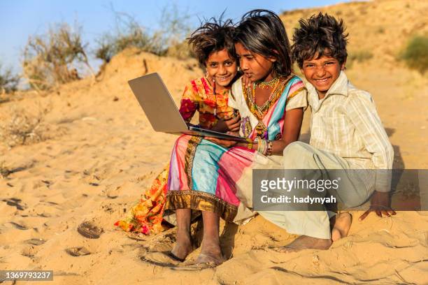 group of happy gypsy indian children using laptop, india - gipsy stock pictures, royalty-free photos & images