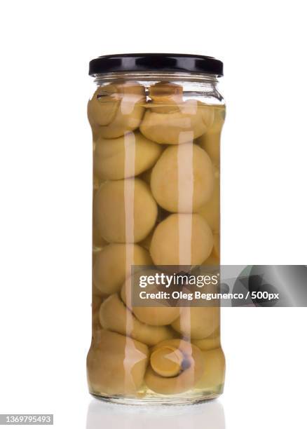 mushrooms marinaded,close-up of jar in jar against white background,moldova - champignon stock-fotos und bilder