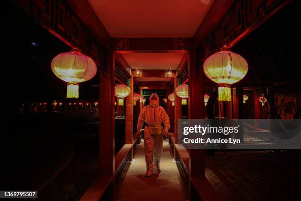 Worker in a hazmat suit works in a hotel restaurant, which is part of the closed-loop Winter Olympics Accommodation Allocation Agreement on February...