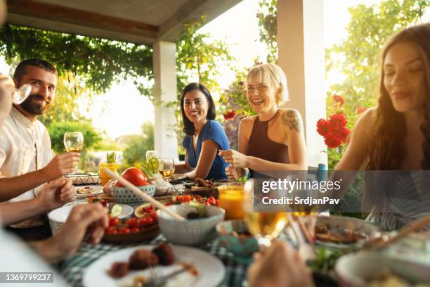 serene caucasian friends, enjoying the brunch in the garden - garden brunch bildbanksfoton och bilder