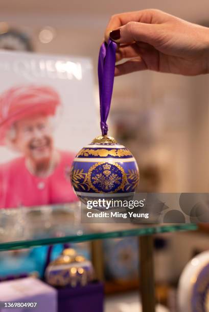 Platinum jubilee Christmas bauble on display at the Buckingham Palace shop on February 7, 2022 in London, United Kingdom. A display of official...