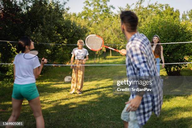 carefree friends playing badminton, during summer day in the garden - game 27 23 stock pictures, royalty-free photos & images