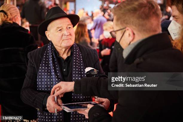 Burghart Klaussner signs an autograph prior tor the "Peter von Kant" premiere and Opening Ceremony during the 72nd Berlinale International Film...