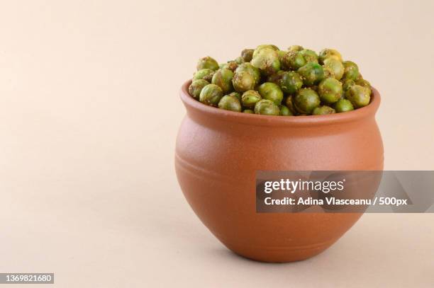 spiced fried green peas chatpata matar indian snack - matar stock pictures, royalty-free photos & images