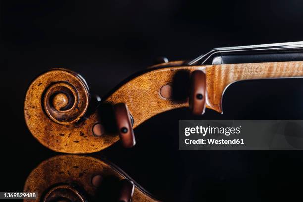 studio shot of violin scroll and tuning pegs - classical stock pictures, royalty-free photos & images