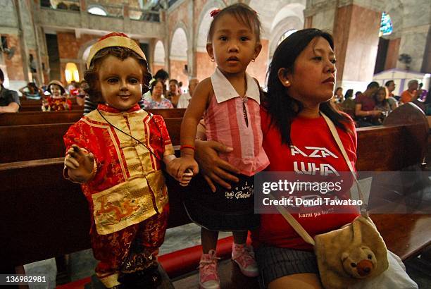 Catholic devotees hold a religious image of the Child Jesus to celebrate the grand procession of the feast of Santo Nino dubbed "Lakbayaw" from the...