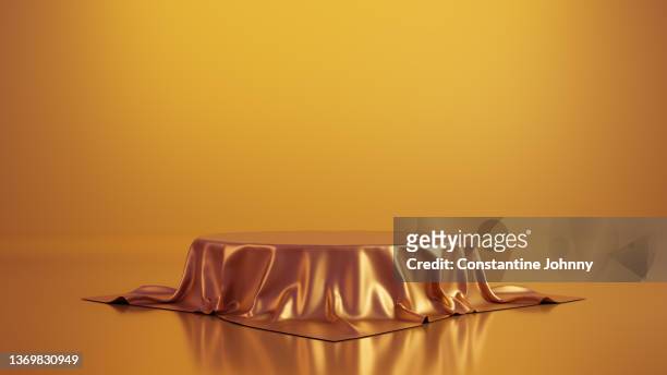 luxury table or podium display stand covered with red silk - winners podium stockfoto's en -beelden