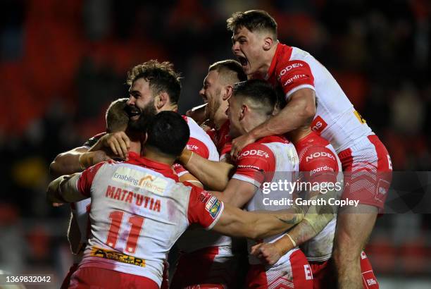 Joey Lussick of St Helens is mobbed by teammates after scoring a second half try during the Betfred Super League match between St Helens and Catalans...