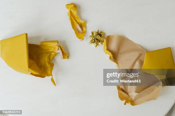 torn gift wrapping paper on table - 包装紙 ストックフォトと画像