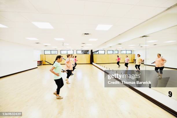extreme wide shot of dance class at retirement community center - dancing studio shot stock pictures, royalty-free photos & images