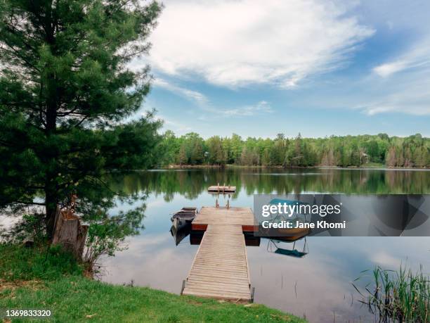 deck on a lake - timber deck stock-fotos und bilder