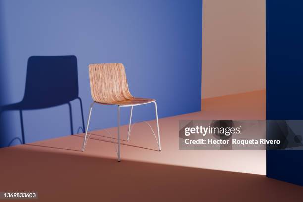 minimal interior of living room with chair and natural light, blue and orange colors - simplicity object stock pictures, royalty-free photos & images