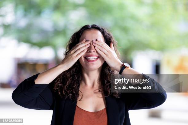 happy businesswoman covering eyes with hands - guess who stock pictures, royalty-free photos & images