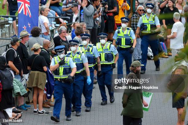 Police walk through the crowd during a protest at Parliament on February 11, 2022 in Wellington, New Zealand. Anti-vaccine and Covid-19 mandate...