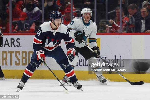 Lars Eller of the Washington Capitals shadows the puck carrier a Matt Nieto of the San Jose Sharks during a game at Capital One Arena on January 26,...