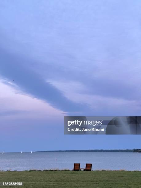 sunset sky and tornado cloud on the lake - jane boone stock-fotos und bilder