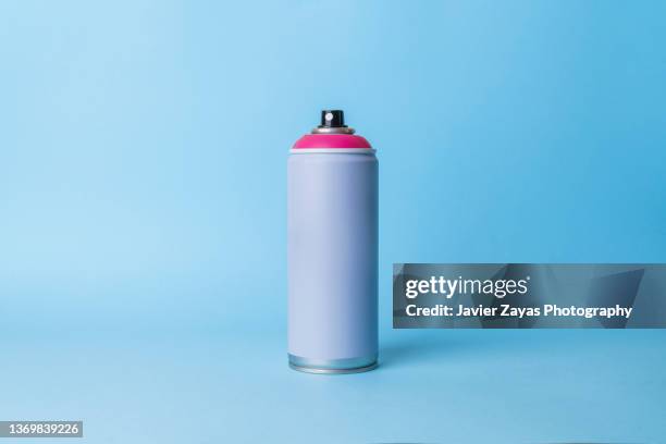 aerosol spray can on blue background - spray bottle stock pictures, royalty-free photos & images