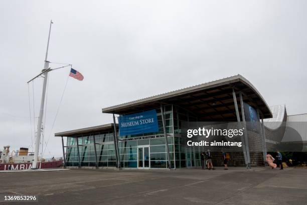 tourists standing outside columbia river maritime museum - columbia river stock pictures, royalty-free photos & images