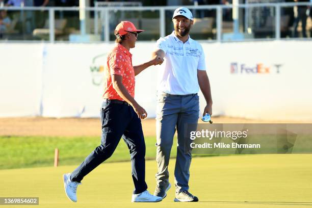 Jon Rahm of Spain reacts to Rickie Fowler's eagle chip on the 17th hole during the first round of the WM Phoenix Open at TPC Scottsdale on February...