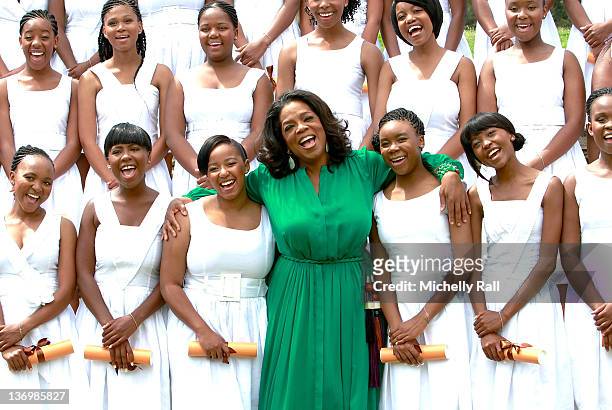 Portrait of American business woman and television personality Oprah Winfrey as she poses with the graduates from the inaugural class at the Oprah...