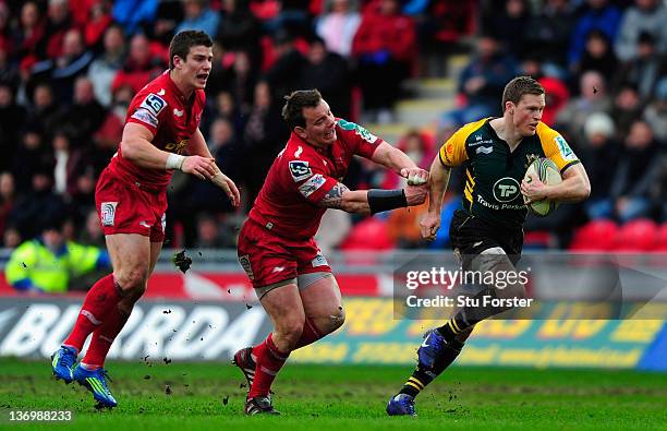 Scarlets hooker Matthew Rees is pushed aside by Chris Ashton of the Saints during the Pool One Heineken Cup Match between Scarlets and Northampton...