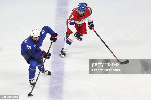 Grace Zumwinkle of Team United States skates the puck over the blue line as Lenka Serdar of Team Czech Republic pursues the play in the third period...