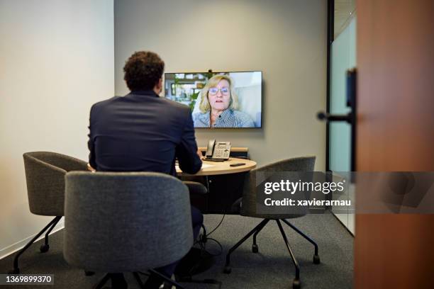 businessman exchanging ideas with colleague on video call - two people video conferencing stock pictures, royalty-free photos & images