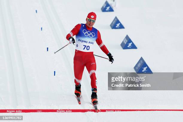Alexander Bolshunov of Team ROC crosses the finish line during the Men's Cross-Country Skiing 15km Classic on Day 7 of Beijing 2022 Winter Olympics...