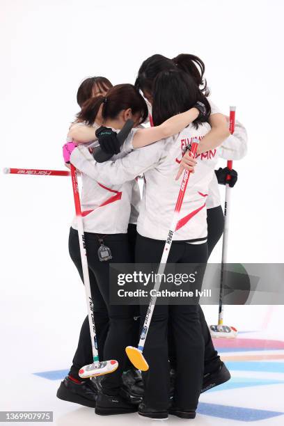 Yurika Yoshida, Yumi Suzuki, Chinami Yoshida and Satsuki Fujisawa of Team Japan celebrate their victory against Team Canada during the Women's Round...