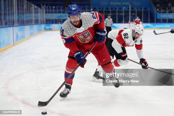 Tomas Kundratek of Team Czech Republic challenges Simon Moser of Team Switzerland during the Men's Ice Hockey Preliminary Round Group B match on Day...